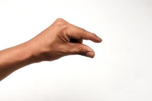 Hand of a Latino man holding something small, isolated on white background. Gesture indicating a pinch or a grab. Small, ideal for interaction and communication concepts. Close-up view. photo