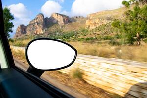 A view of a mountain range from a car window photo