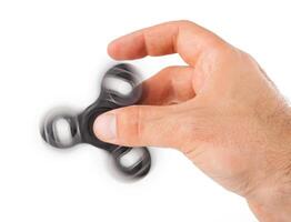 Palying with a Black Fidget Spinner photo
