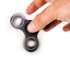 Palying with a Black Fidget Spinner photo