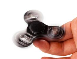 Palying with a Black Fidget Spinner photo