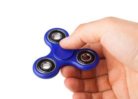 Playing with a blue Fidget Spinner photo