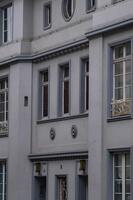 Elegant grey facade with decorative elements and windows photo