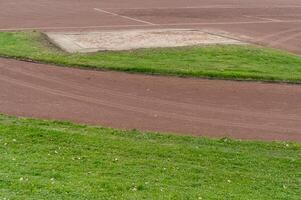 Long jump sand pit and running track on a cloudy day photo