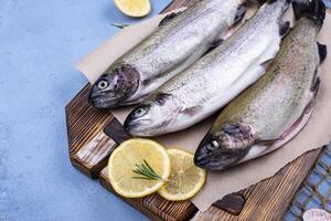 Raw uncooked trout with lemon photo