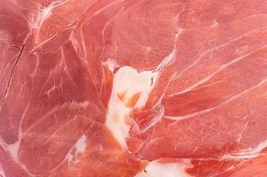 Hamon meat thin slice as macro photo background.