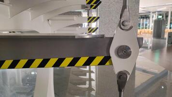 Close-up of metal support structure with caution stripes in modern interior photo