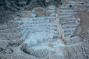 Aerial view of Open-air mining activity in a white marble mine. photo