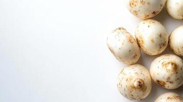 Several jicama tubers are displayed on a white surface, emphasizing their round shape and speckled skin. This vibrant and crunchy root vegetable is ready for culinary use photo