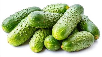 A vibrant group of fresh cucumbers displays their smooth skin and rich green color on a plain white background, highlighting their nutritious appeal and freshness photo