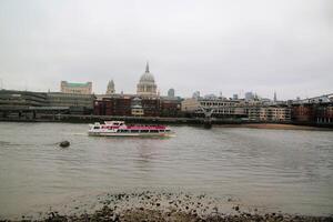 A boat is floating in the water near a city photo