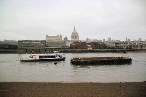 A boat is floating in the water next to a building photo