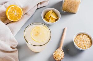 Trendy rice and lemon drink to reduce appetite in a glass on the table photo
