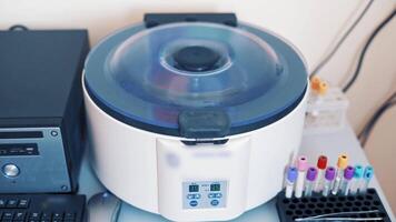 Platelet rich plasma preparation. Tubes with blood in a rack on the table near the automated machine. Modern centrifuge machine in medical laboratory. video