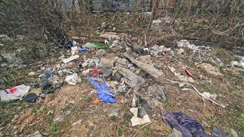 Different garbage lying on the ground in nature. A lot of plastic bottles, litter around the natural background. Pollution problem. video