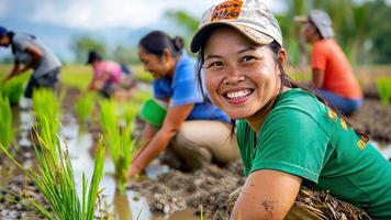 A woman smiles while working in a rice field video