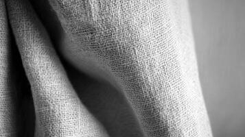 Close up of textured fabric with light gray natural fibers in soft folds. photo