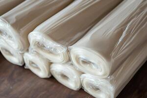 Stacks of polyethylene film rolls packaged for efficient transport and use in packaging solutions. photo