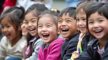 A group of diverse children enjoys each others company, laughing and smiling joyfully photo