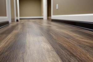 Closeup of newly installed vinyl plank flooring and baseboards enhancing room aesthetics. photo