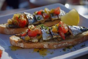 Delicious sardines on toast served with fresh toppings and a squeeze of lemon photo
