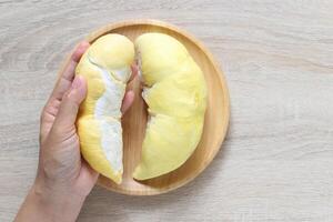 Durian king of fruit, Fresh durian fruit in a bowl on wooder background, Healthy eating concept photo