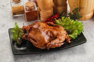 Baked small chicken with spices photo