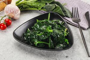 Coocked green spinach with oil photo