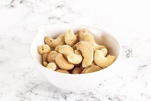 Cashew nuts heap in the bowl photo