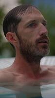 Taking a serene moment to relax in the cool waters of a beautiful swimming pool environment video