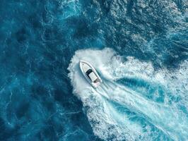 Aerial view of a speedboat racing across the open ocean photo