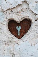Rustic heart shaped hole with key photo