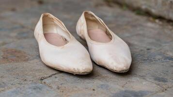 Worn ballet flats on a concrete surface photo