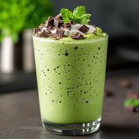 Delicious green smoothie with chocolate shavings and mint photo