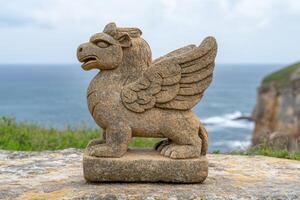 Mythical stone creature overlooking the ocean photo