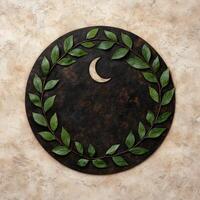 Crescent moon and leaf wreath on stone background photo
