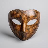 Mysterious venetian mask with cracked and weathered surface photo