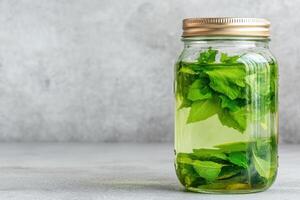 Refreshing mint tea in glass jar photo