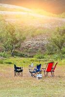 Camping site with camp-chairs and table photo