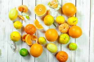 Citrus fresh fruit on the white wooden table photo