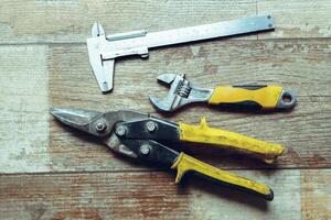 Working tools on wooden rustic background. top view photo