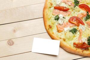 Pizza with blank paper with copy space photo