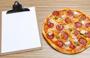 Pizza with blank paper with copy space photo