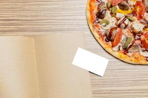 Pizza with blank paper with copy space photo