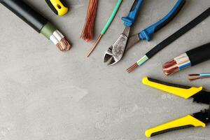 Electrical Tools and Wires on Gray Surface photo