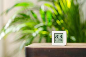 White Digital Thermometer Displaying Temperature and Humidity photo