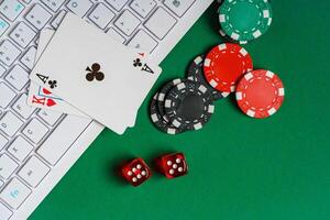 Playing Cards, Dice, and Chips on Green Felt Gaming Table With Keyboard photo