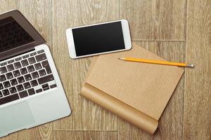 Office table with smartphone on it. View from above photo