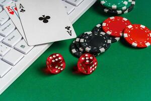 Playing Cards, Dice, and Chips on Green Felt Gaming Table With Keyboard photo