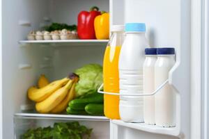 Open Refrigerator Door With Juice, Milk, and Fresh Produce photo